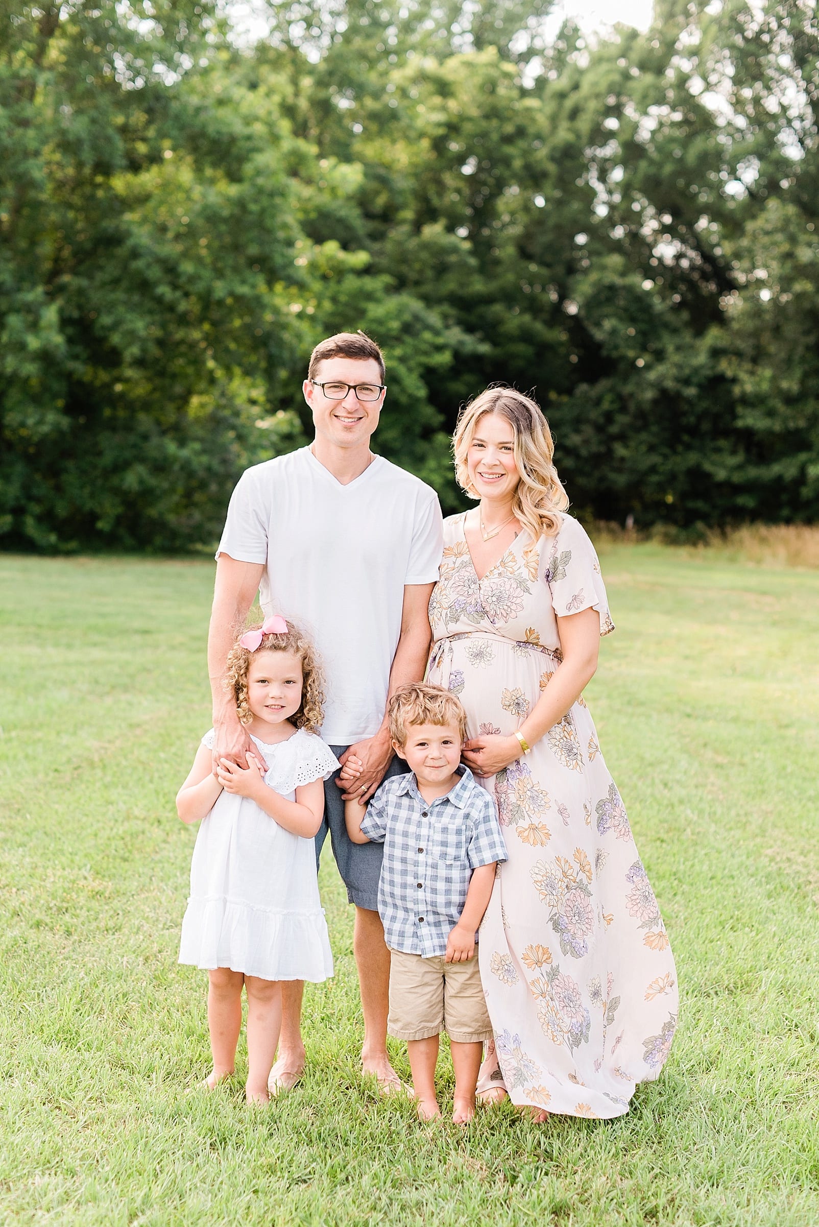 Wake Forest family of four mother in long light pink floral maternity dress photo