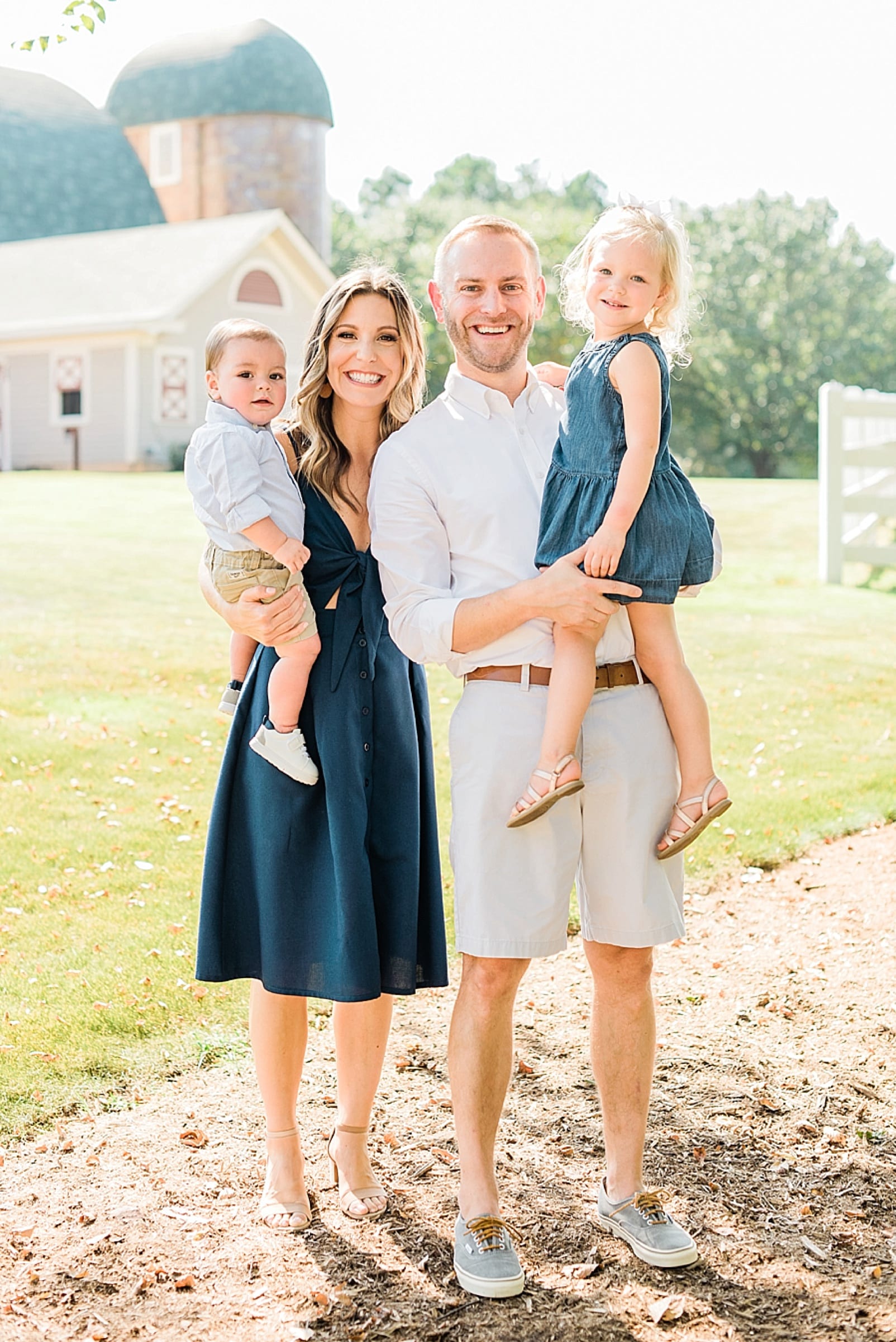 Wake Forest family of 4 with a son and a daughter standing in front of the Historic Wakefield Barn photo