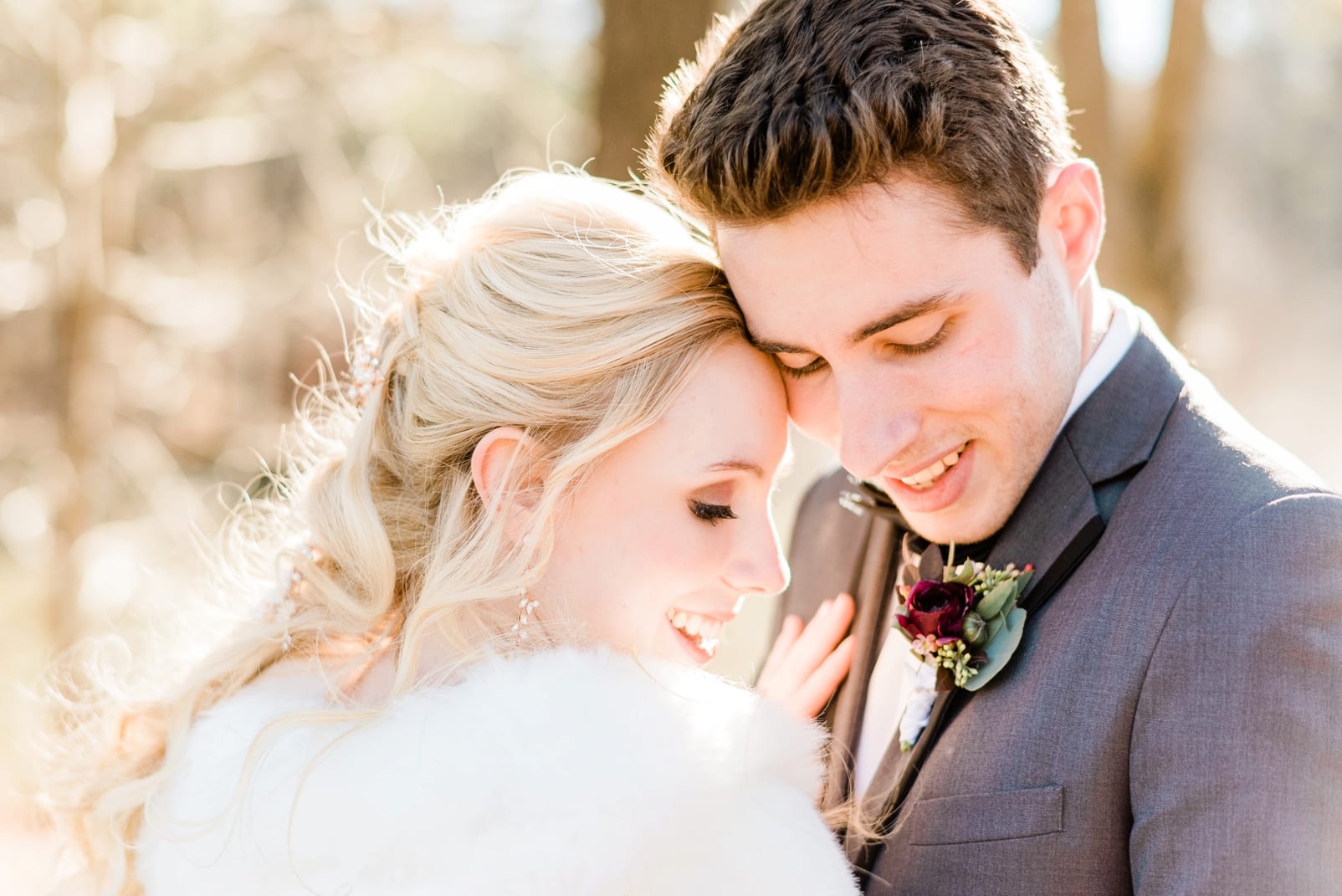 Angus Barn bride and groom snuggled with their heads together while smiling photo