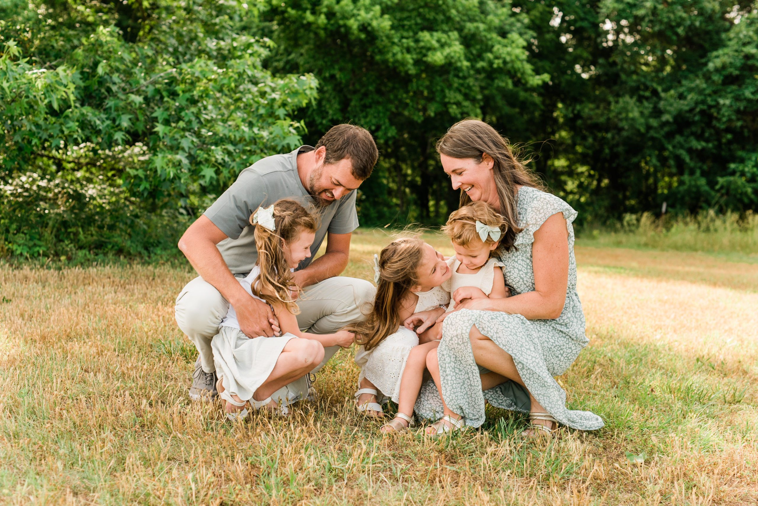 Wake Forest Family Portraits with a lifestyle feel. Parents tickling their daughters