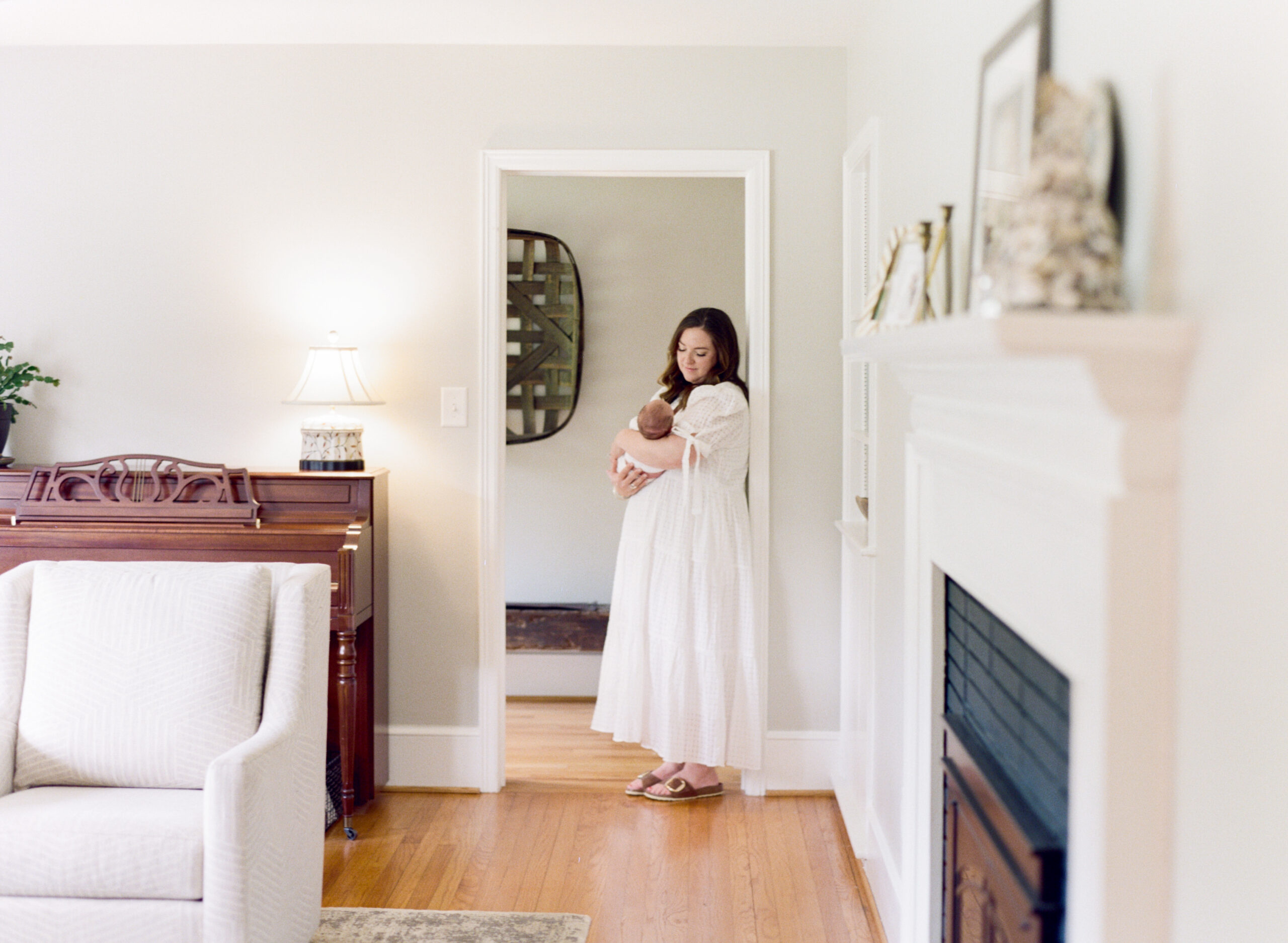 Mom leans in a doorway during a newborn session in Mebane NC. Image by Mebane newborn photographer A.J. Dunlap Photography.