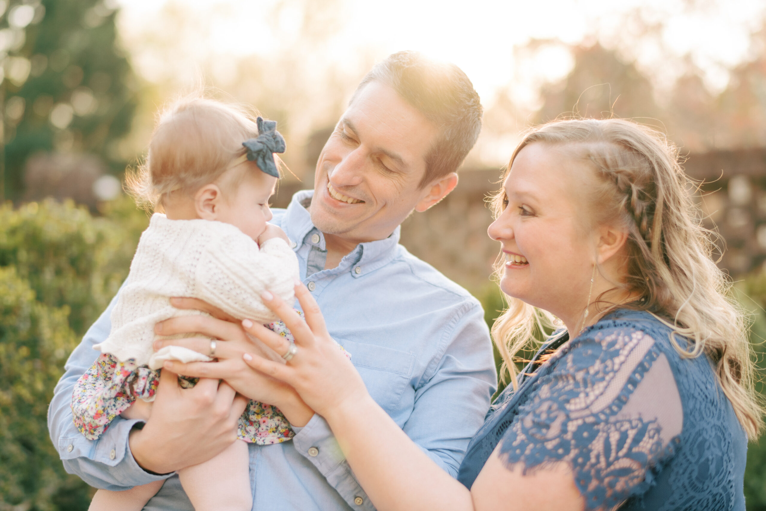 Image of mom and dad playing with their baby by Wake Forest Family Photographer A.J. Dunlap Photography